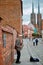 Street musician with saxophone on pedestrian Tumski Bridge with Cathedral of St. John the Baptist on the background. Wroclaw