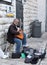 Street musician sits on the street and plays the guitar in the old city of Jerusalem, Israel