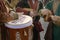 Street musicians in national costumes play folk instruments - a drum and a dombra during