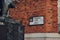 Street name sign on Sermon Lane in the City of London, UK, from behind the monument, selective focus