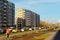 Street with a new building, economy class residential buildings against the blue sky, Russia