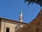 Street in the old city of Acre in Israel. Nice view of the minaret against the blue sky.