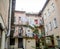 Street in the old courtyard surrounded by houses with windows and balconies in Lviv