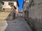 Street of old residential buildings in the slums of Ankara Castle in the capital of Turkey. Stone road, gray cracked walls of