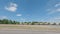 Street pan of an empty retail strip mall with cones in an empty parking lot