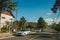 Street with parked cars and trees in Gramado