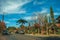 Street with parked cars and trees in Gramado