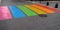 Street pedestrian crossing in colors rainbow flag sign to sex discrimination concept of the LGBT community in city center