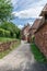 Street with perfectly preserved medieval residential masonry buildings on outskirts of Collonges-la-Rouge