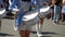 Street performance after quarantine. Close-up of female hands drummers are knocking in the drum of their sticks