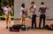 Street performer in amsterdam with reflection wall, playing violine and saxophon