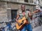 Street performer with guitar poses outside Eglise Saint Eustache in Paris