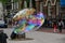 A street performer making large soap bubbles on the streets of Amsterdam