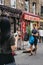 Street performer singing and playing guitar at Columbia Road Flower Market, London, UK.