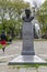 Street Photography. Brooklyn New York John F. Kennedy bust at Grand Army Plaza gardens.