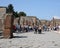 Street at Pompeii ruins in Italy with tourists.