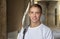 Street portrait of a smiling young guy 20-25 years old with a backpack on his shoulder against the background of old urban archite