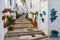 Street in Pueblos blancos in Spain. Village called Frigiliana. Typical aisle full of flower pots between white houses in Andalusia