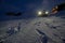 Street of residential area of Selfoss completely snow covered, with human footprints and a 4x4 jeep parked next to a house