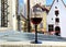 Street restaurant glass of red wine on table top street clock  urban medieval city lifestyle Tallinn old town  summer  travel to E