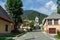Street Scenario with buildings during main Road and main Parish Church of Village Log pod Mangartom. Bovec, Slovenia, Europe