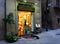 Street scene in Barcelona, Spain with small Spaniel by the door of gallery