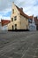 Street scene in Bruges / Brugge, Belgium with yellow house and cobblestone paving