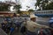 Street scene in the city of Antigua, in Guatemala, with a local man in the foreground and two buses on the background, in Guatemal