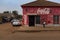 Street scene in the city of Bissau with man passing in front of a restaurant, in Guinea-Bissau, West Africa