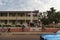 Street scene in the city of Bissau people walking in a sidewalk in front of a church, in Guinea-Bissau