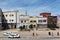 Street scene in the city of El Jadida with people on a sidewalk and buildings on the background