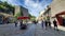 Street scene in downtown Quebec with a diverse group of pedestrians strolling along the sidewalk.