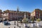 Street scene with a fountain, a bike taxi and historic buildings at Place MassÃ©na in Nice, France