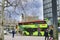 Street scene with a green bus for tourists in Berlin, Germany.