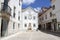 Street scene in the old town, white house with ornate fountain, Torres Vedras, Portugal