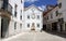 Street scene in the old town, white house with ornate fountain, Torres Vedras, Portugal