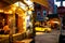 Street scene with restaurant, lights, and people at night seen from Greenwich Village, West Village Manhattan.