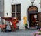 Street scene Tallinn old town Estonia 20,08,2019  medieval cart with an awning girl sells almonds fried in sugar near the city tow