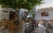 Street scene with tavernas and square, on aegean island of Tinos, Greece.