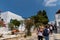 Street scene with tourists strolling, on aegean island of Tinos, Greece.