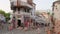 Street scene with tourists walking in old town of Gjirokaster, Albania