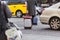 Street scene with an unidentified man with a wheeled suitcase crossing a street