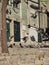 Street scene with upflying doves in the historic district Santana, Lisbon, Portugal.