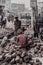 Street scene of workers  breaking bricks by hand to reuse them on the streets, Dhaka, Bangladesh