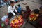 Street seller on the banks of the sacred Ganges river selling flower petals