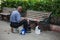 Street shoe polisher sit lonely waiting for clients at the Bolivar park in the