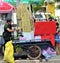 Street side sugar cane juice seller and mobile stall in asia