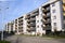 Street, sidewalk, modern apartment building in contemporary residential district