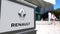 Street signage board with Groupe Renault logo. Blurred office center and walking people background. Editorial 3D