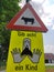 Street signs - take care a child in combination with attention cows